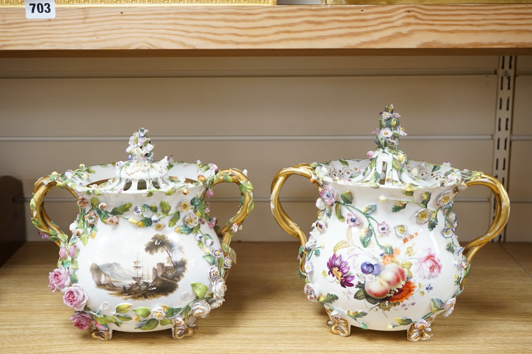 A pair of Rockingham two handled pot pourri vases and covers, c.1830-42, the first painted with two named views near Lyme, Dorsetshire and Stockly Bridge’, The second with an unnamed view of a monument by a lake, the rev
